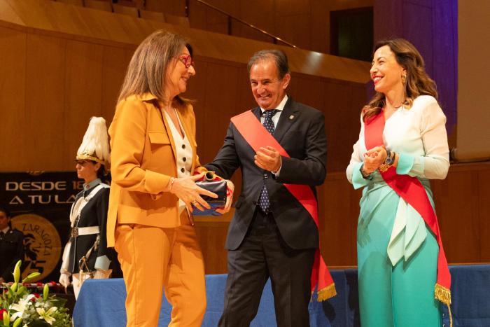 La directora gerente del Banco de Sangre y Tejidos de Aragón recogiendo la distinción de manos de la alcaldesa de Zaragoza, Natalia Chueca