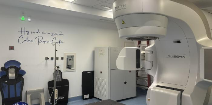 Equipo de radioterapia (acelerador lineal) en una sala preparada para el tratamiento de pacientes oncológicos, con sistemas de alta precisión.