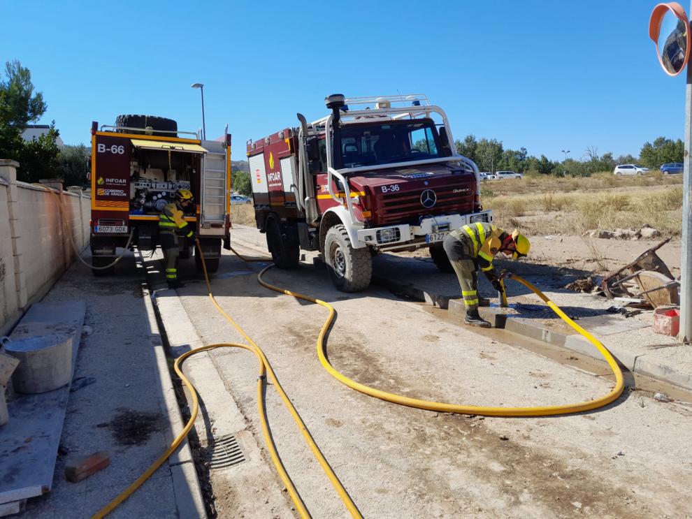 Efectivos del Infoar sanean una de las calles afectadas por la tormenta del pasado domingo que desbordó el Huerva